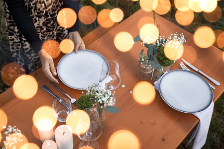 Wide beer garden table set is romantically set and decorated. 