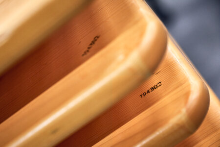 Several wooden boards in pine are stacked on top of each other.