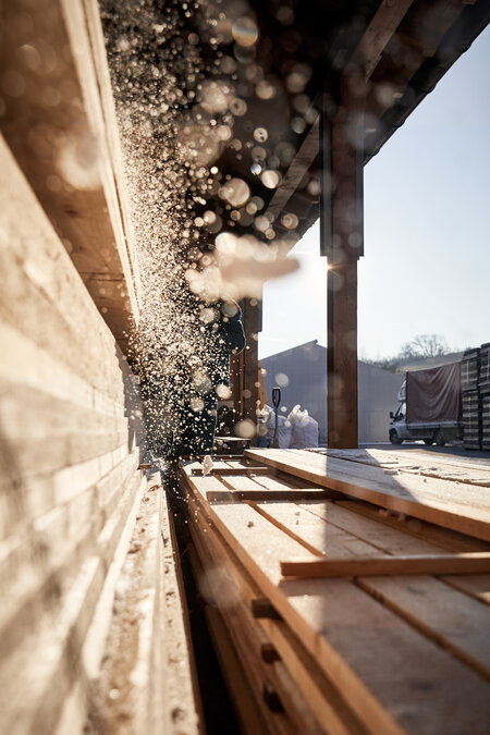 The image shows a cinematic shot from the RUKU1952 carpentry workshop in Romania.