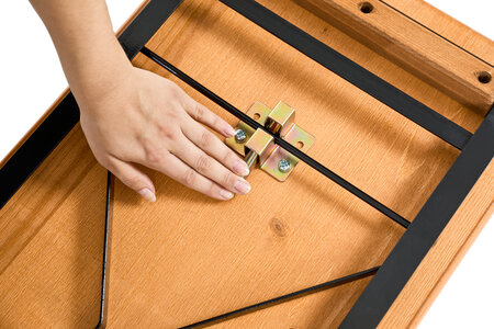 he folding mechanism of a beer garden table set is being opened.
